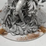 Kingdom Death Parasite Queen custom scenic base work in progress, front view showing tentacles, texture, and grass tufts on round base