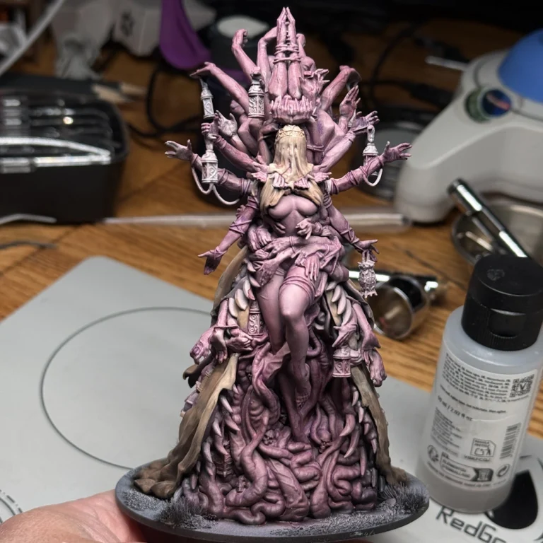 Kingdom Death Parasite Queen work in progress after red wash on skin and teal color on fabric, showing enhanced depth and contrast